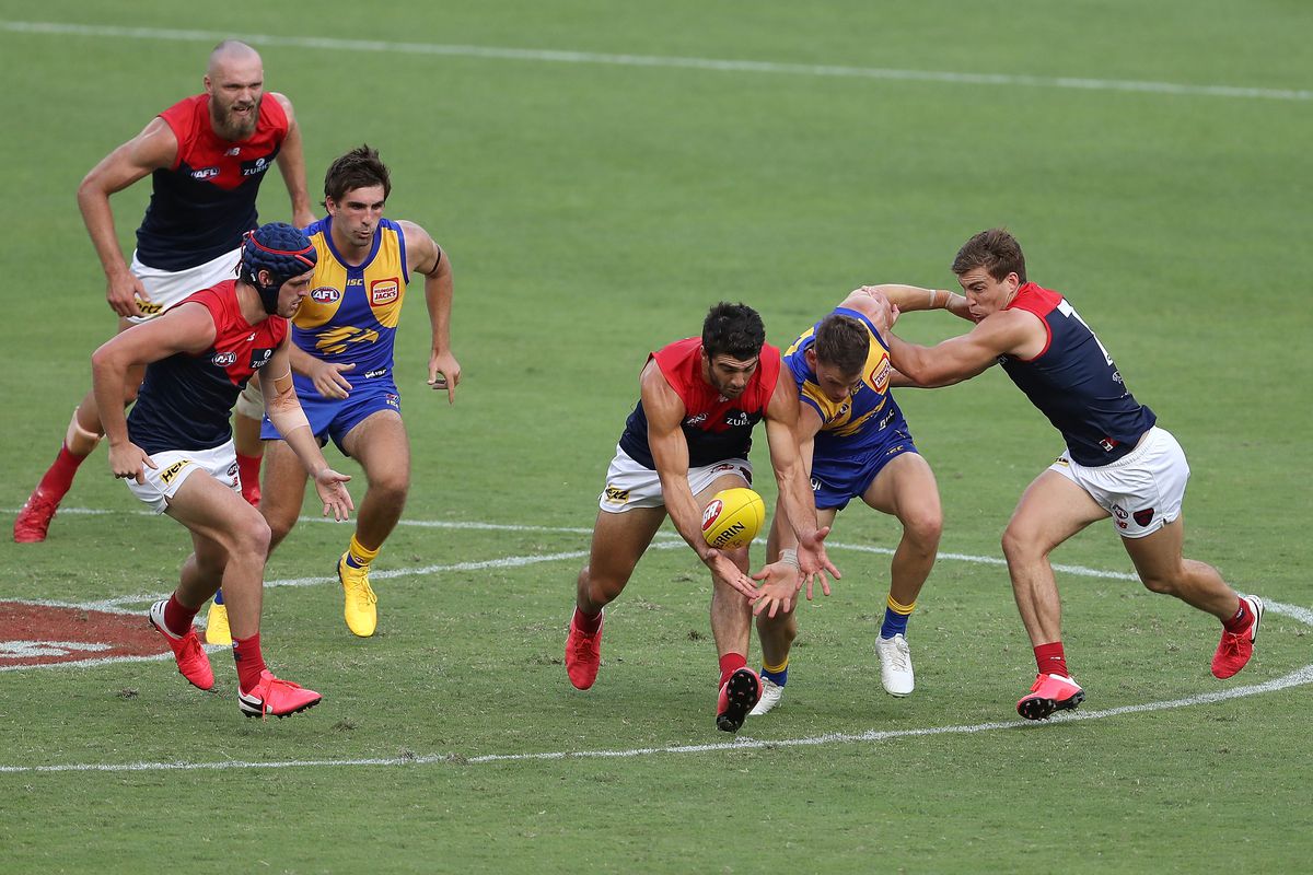 Christian Petracca of the Demons and Jack Redden of the Eagles contest for the ball during the round 1 AFL match between the West Coast Eagles and the Melbourne Demons at Optus Stadium on March 22, 2020 in Perth, Australia.