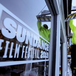 Marc Lee hangs a Festival Store sign before the start of the 2019 Sundance Film Festival in Park City on Tuesday, Jan. 22, 2019.