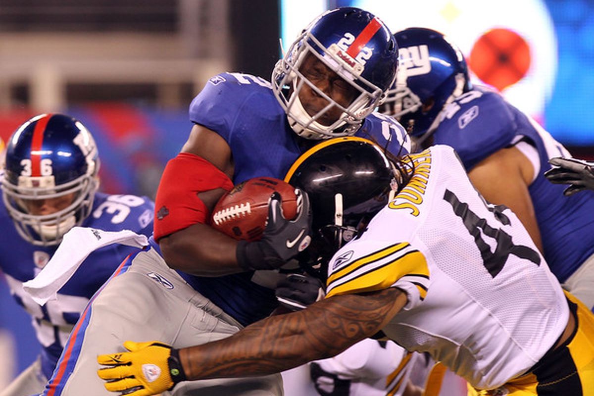 Andre Brown (22) of the New York Giants is tackled by Frank Summers (44) of the Pittsburgh Steelers during their preseason game at New Meadowlands Stadium on August 21 2010 in East Rutherford New Jersey.  (Photo by Nick Laham/Getty Images)