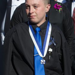 Alex Brotherson, brother of West Valley police officer Cody Brotherson, wears the Medal of Honor that West Valley Police Chief Lee Russo presented to he and his older brother, Braydon, during Cody's funeral at the Maverik Center in West Valley City on Monday, Nov. 14, 2016.