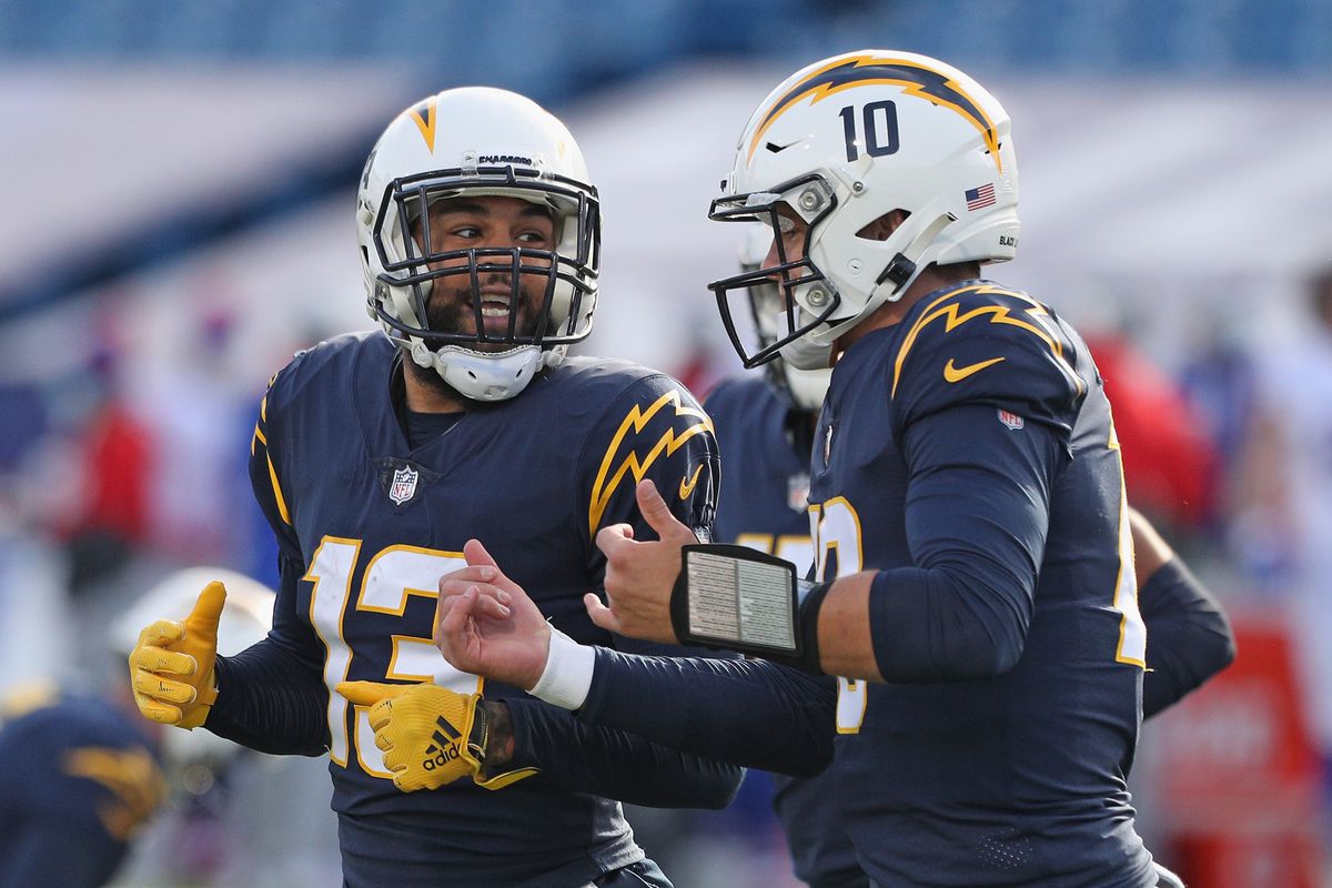 Keenan Allen #13 and Justin Herbert #10 of the Los Angeles Chargers celebrate a first quarter touchdown against the Buffalo Bills at Bills Stadium on November 29, 2020 in Orchard Park, New York.