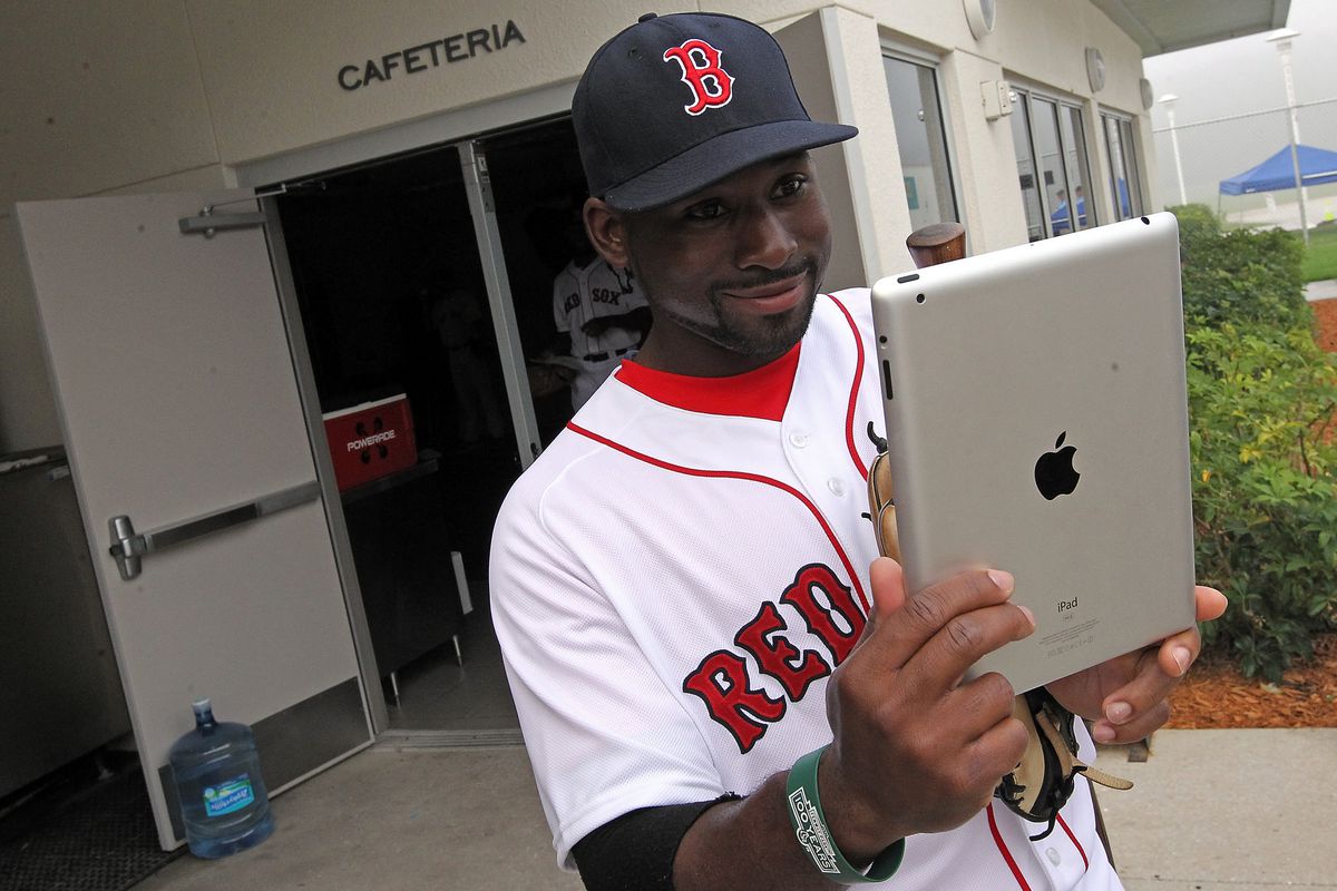 (Fort Myers, FL, 02/23/14) Using an iPad, Boston Red Sox center fielder Jackie Bradley Jr. photographs himself and then Tweets it during Picture Day at Red Sox Spring Training on Sunday, February 23, 2014. Staff Photo by Matt Stone