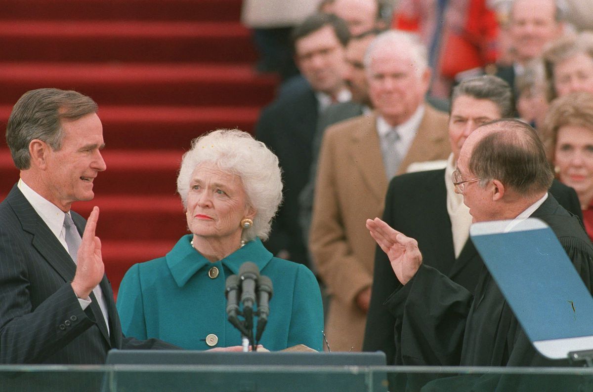 President George H.W. Bush is sworn into office as the 41st president of the United States by Chief Justice William Rehnquist on Jan. 20, 1989. First lady Barbara Bush holds the Bible for her husband. | Associated Press