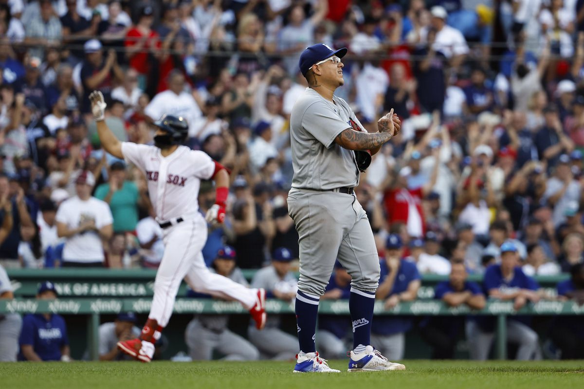 Pitcher Julio Urias of the Los Angeles Dodgers walks off the mound as Adam Duvall of the Boston Red Sox rounds the bases on his three-run home run during the sixth inning at Fenway Park on August 26, 2023 in Boston, Massachusetts.