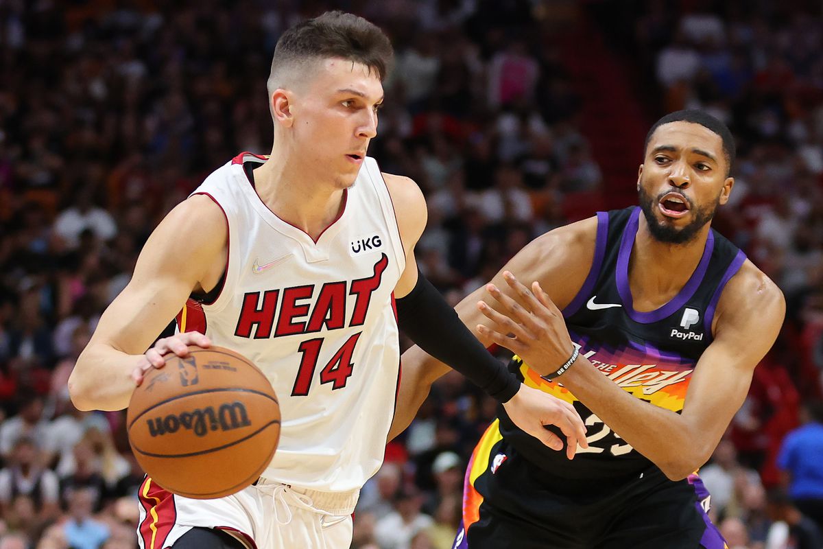 Tyler Herro #14 of the Miami Heat drives to the basket against Mikal Bridges #25 of the Phoenix Suns during the first half at FTX Arena on March 09, 2022 in Miami, Florida.