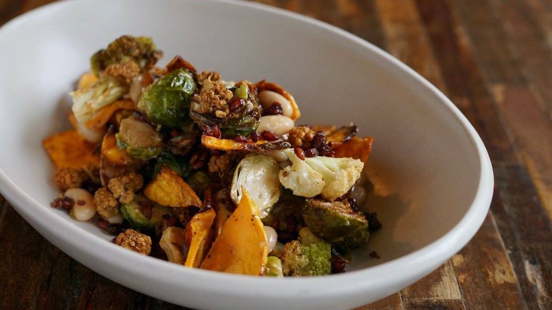 Squash, brussels sprouts, cauliflower and other roasted vegetables in a bowl. 