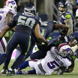 Buffalo Bills quarterback Tyrod Taylor (5) is sacked by Seattle Seahawks middle linebacker Bobby Wagner (54) and defensive end Cliff Avril, top-center, in the second half of an NFL football game, Monday, Nov. 7, 2016, in Seattle. The Seahawks beat the Bills 31-25. (AP Photo/Elaine Thompson)