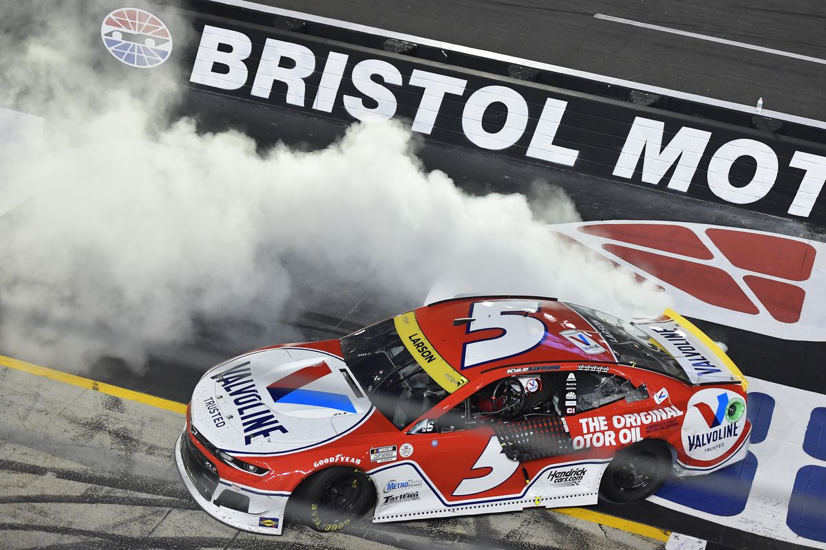 Kyle Larson, driver of the #5 Valvoline Chevrolet, celebrates with a burnout after winning the NASCAR Cup Series Bass Pro Shops Night Race at Bristol Motor Speedway on September 18, 2021 in Bristol, Tennessee.