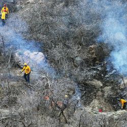 Firefighters respond Sunday, Feb. 8, 2015, to a small brush fire at the mouth of Big Cottonwood Canyon.