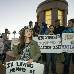 In this photo taken on Monday, Feb. 9, 2015, Seema Kassab, in front, of The Muslim Liberty Project (MLP) holds a candlelight vigil in honor of victims of the Islamic State group at the Hayden Lawn, Arizona State University Tempe, Ariz., Campus. The vigil recognized IS hostage Kayla Mueller, an aid worker from Prescott, Ariz., who was taken in Aleppo on Aug.  4, 2013. 