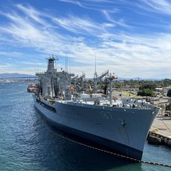 USNS Henry J. Kaiser (T-AO-187) sits tied up off the bow of the USS Abraham Lincoln (CVN-72). The Kaiser is a United State Navy fleet replenishment oiler and lead ship of her class. She resupplies the U.S. Navy and allied ships at sea with fuel oil, jet fuel, lubricating oil, potable water, and dry and refrigerated goods, including food and mail.