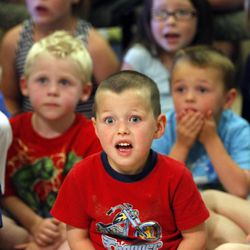 Kids react as Shane Richins of Scales and Tails Utah pulls out an Asian water monitor during his show Wednesday, June 5, 2013, during Heber Unplugged at the Wasatch County Library.