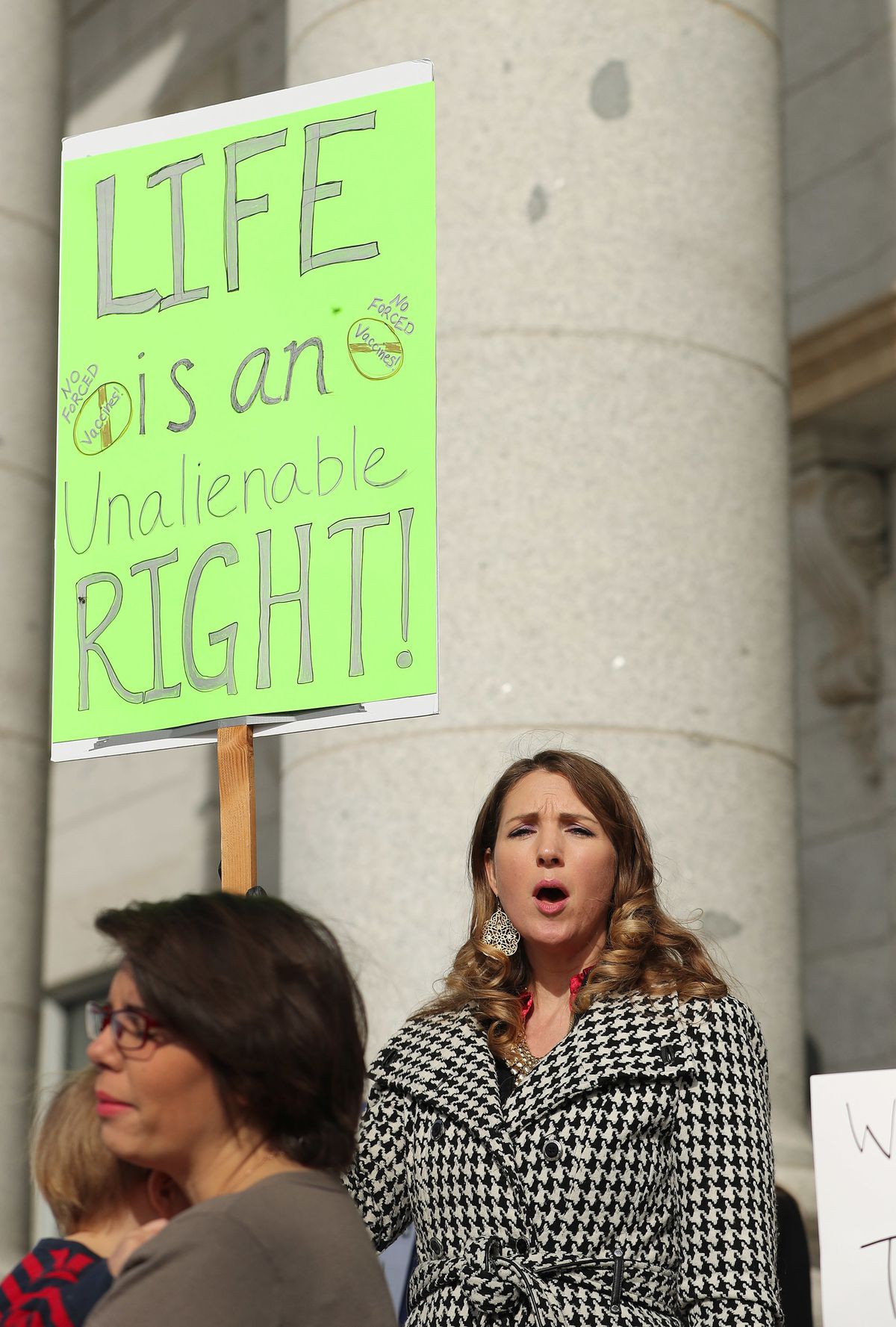 Tatia Nelson holds a sign as members of Your Health Freedom rally at the Capitol in Salt Lake City on Tuesday, March 5, 2019.