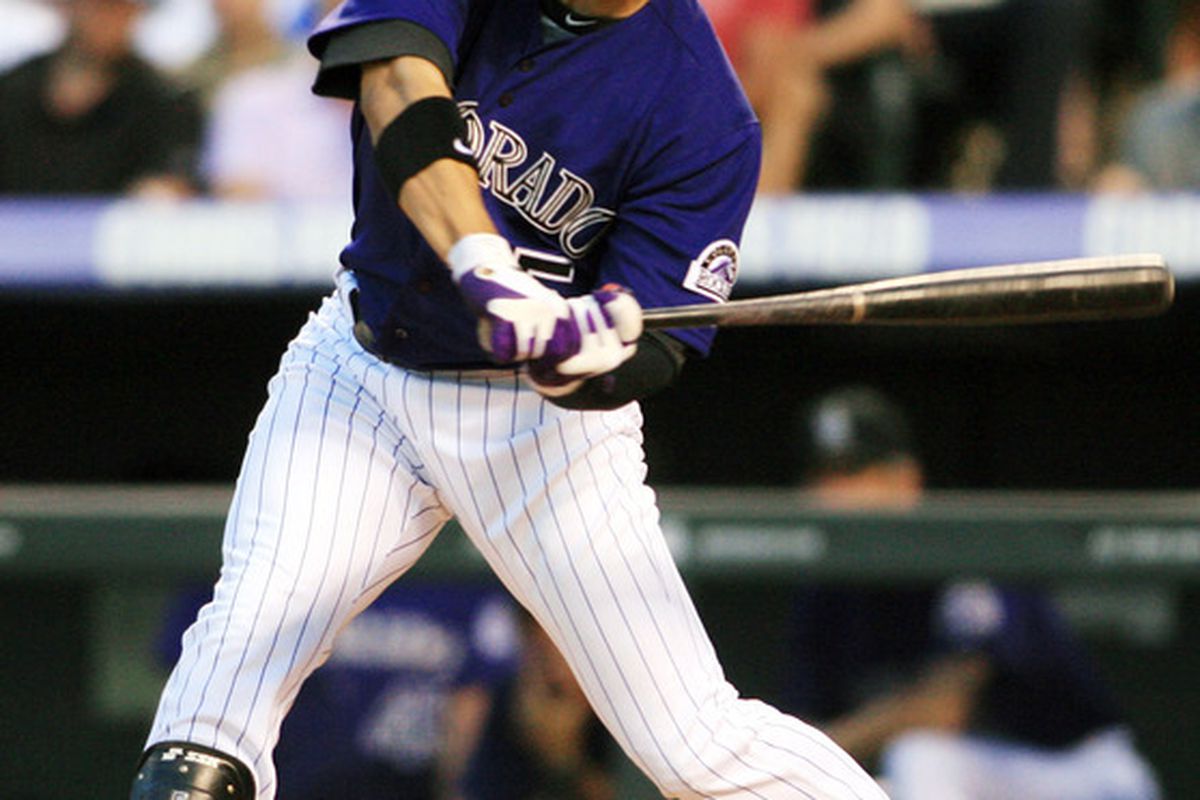June 25, 2012; Denver, CO, USA; Colorado Rockies left fielder Carlos Gonzalez (5) hits an RBI single during  the sixth inning against the Washington Nationals  at Coors Field.  Mandatory Credit: Chris Humphreys-US PRESSWIRE