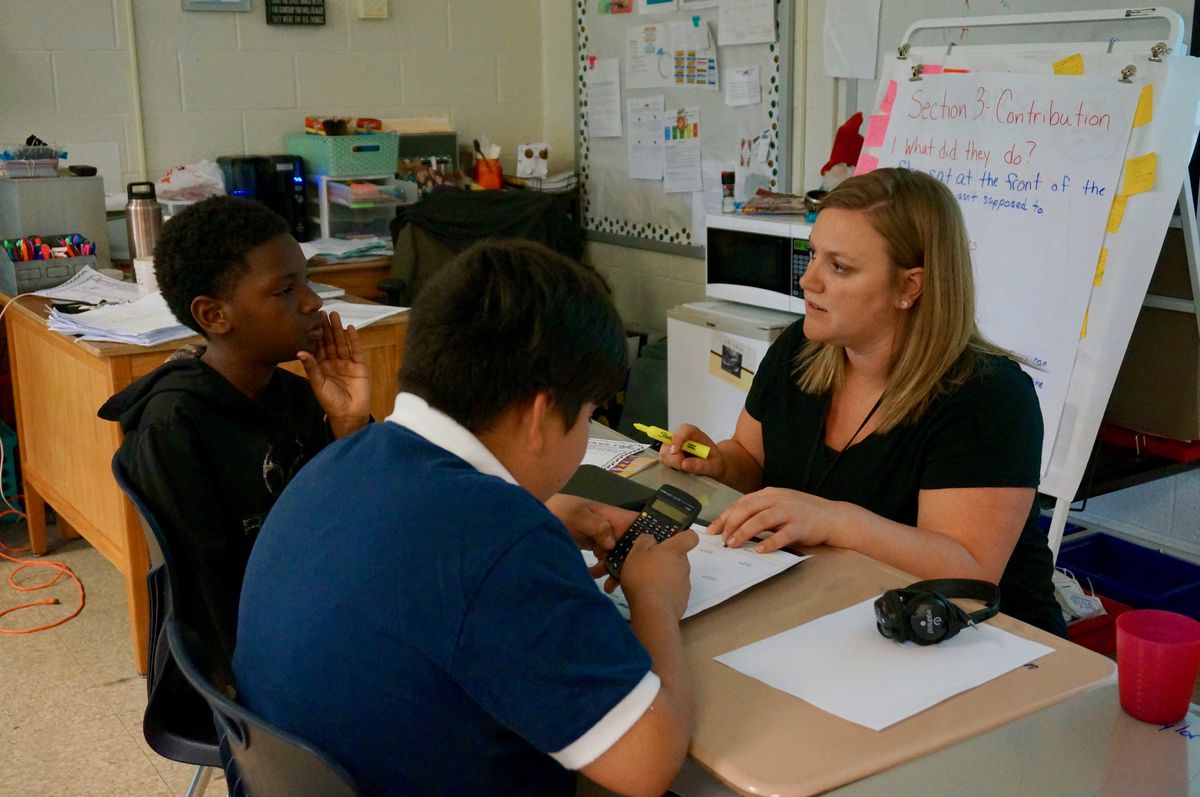 Teacher Abby Campbell works on math with her fourth-grade class.