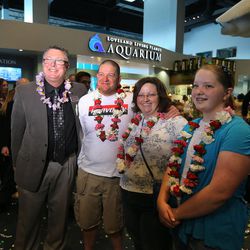 CEO Mike Vermillion poses with Troy Yates, his wife, Kendra Yates, and daughter Krystal Yates after they won a trip for four to Hawaii by being the 1,000,000th visitor to the Loveland Living Planet Aquarium in Draper Monday, Feb. 16, 2015.