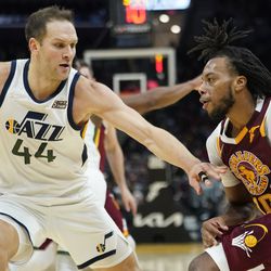 Cleveland Cavaliers’ Darius Garland, right, drives to the basket against Utah Jazz’s Bojan Bogdanovic (44) in the second half of an NBA basketball game , Sunday, Dec. 5, 2021, in Cleveland. 