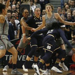UConn’s Katie Lou Samuelson (33) draws the charge from Notre Dame's Arike Ogunbowale (24) during the Notre Dame Fighting Irish vs UConn Huskies women's college basketball game in the Women's Jimmy V Classic at the XL Center in Hartford, CT on December 3, 2017.