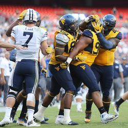 West Virginia players celebrate after stopping BYU at FedEx Field in Landover, Maryland on Saturday, Sept. 24, 2016.