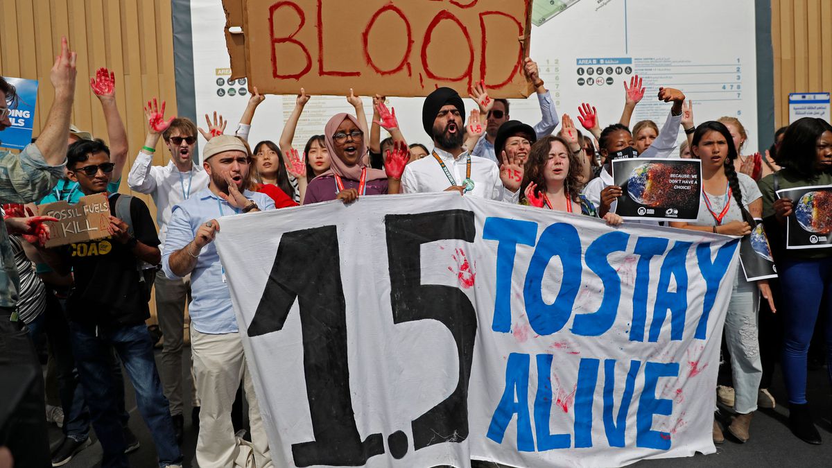 Activists chant slogans as they hold up a banner reading “1.5 to stay alive,” referring to demands to limit global temperature rise to 1.5 degrees Celsius compared to pre-industrial levels, during a demonstration at the COP27 climate conference in Sharm el-Sheikh, Egypt in 2022.