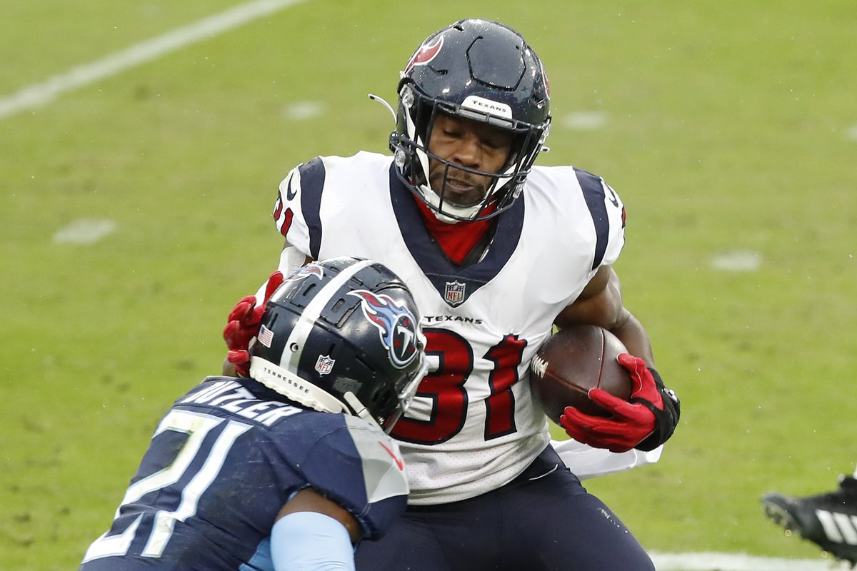 Running back David Johnson #31 of the Houston Texans runs with the ball against Malcolm Butler #21 of the Tennessee Titans in the second quarter at Nissan Stadium on October 18, 2020 in Nashville, Tennessee.