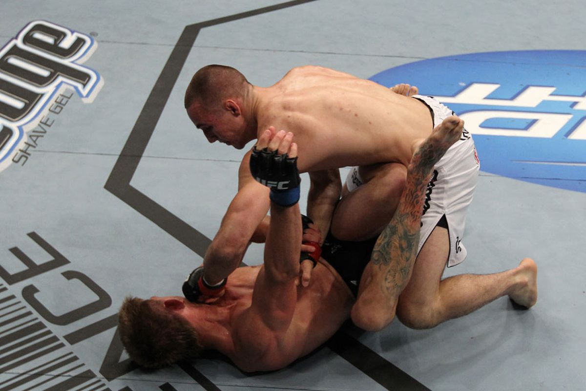 Rory MacDonald punches Mike Pyle from guard at UFC 133. <em>Photo by Josh Hedges/Zuffa LLC/Zuffa LLC via Getty Images</em>