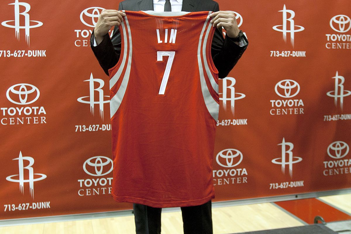 HOUSTON, TX - JULY 19: Jeremy Lin of the Houston Rockets displays his jersey during a press conference at Toyota Center on July 19, 2012 in Houston, Texas.  (Photo by Bob Levey/Getty Images)