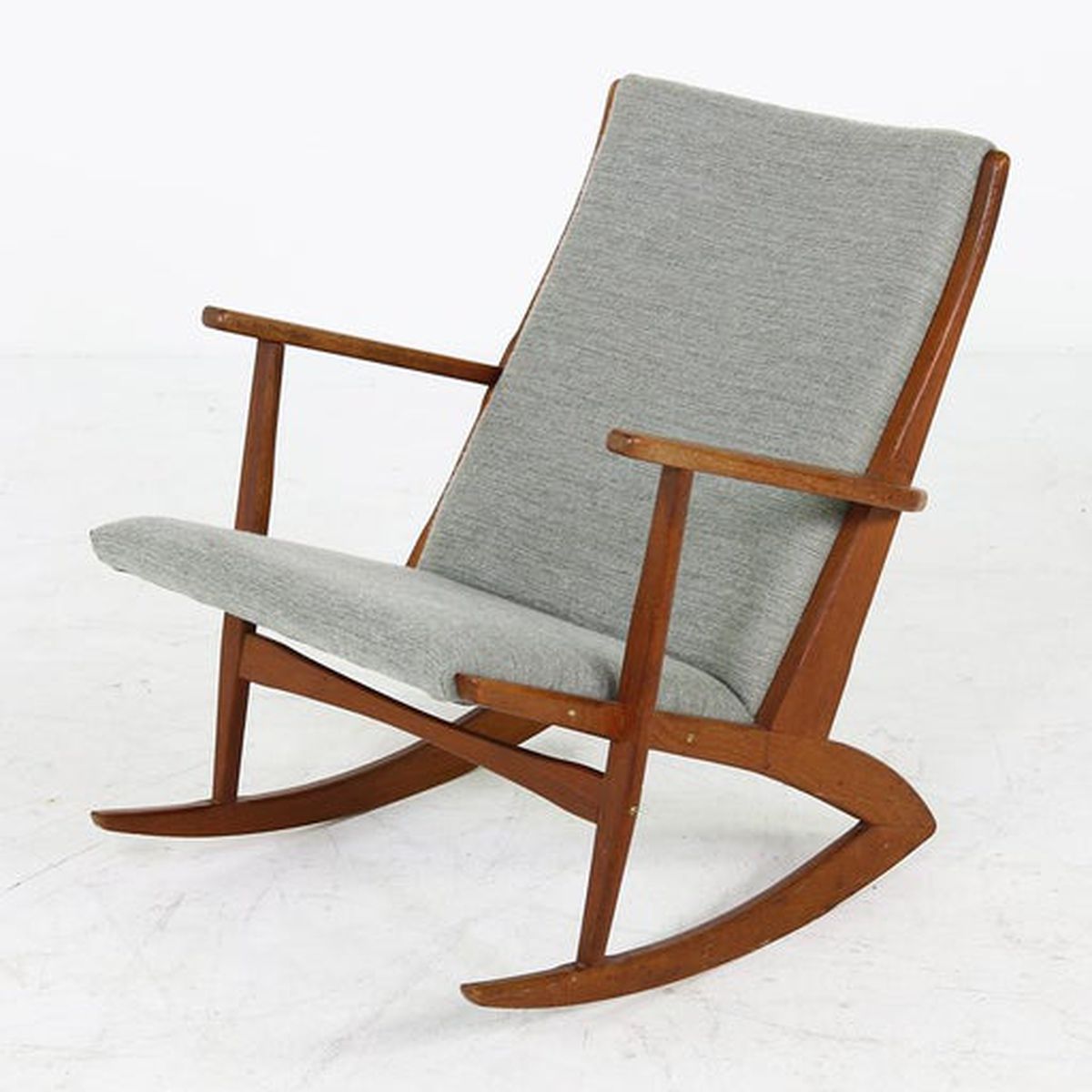 A rocking chair with wooden frame and light gray upholstery. 