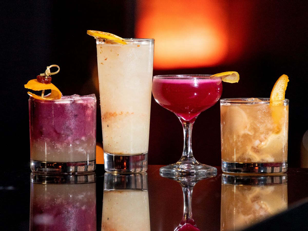 row of four colorful cocktails