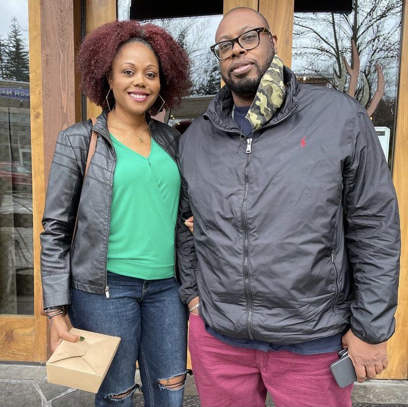 Darnesha (on the left) and Erwin Weary (on the right) of Black Coffee Northwest, both in gray jackets, with Darnesha holding a brown takeout container