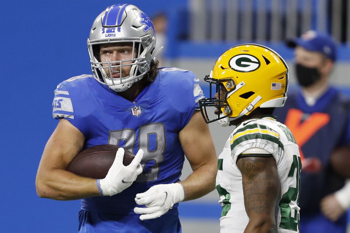 Detroit Lions tight end T.J. Hockenson (88) holds the ball after a play against Green Bay Packers safety Will Redmond (25) during the second quarter at Ford Field.&nbsp;