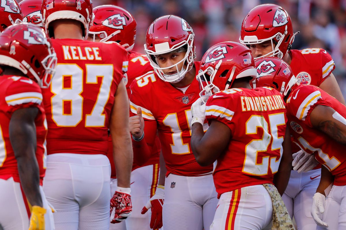 Patrick Mahomes #15 of the Kansas City Chiefs calls the play in the huddle in the first quarter of the game against the Dallas Cowboys at Arrowhead Stadium on November 21, 2021 in Kansas City, Missouri.