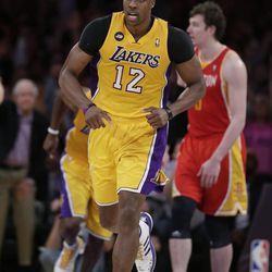 Los Angeles Lakers' Dwight Howard makes his way down the court during overtime of an NBA basketball game against the Houston Rockets in Los Angeles, Wednesday, April 17, 2013. The Lakers won 99-95. (AP Photo/Jae C. Hong)