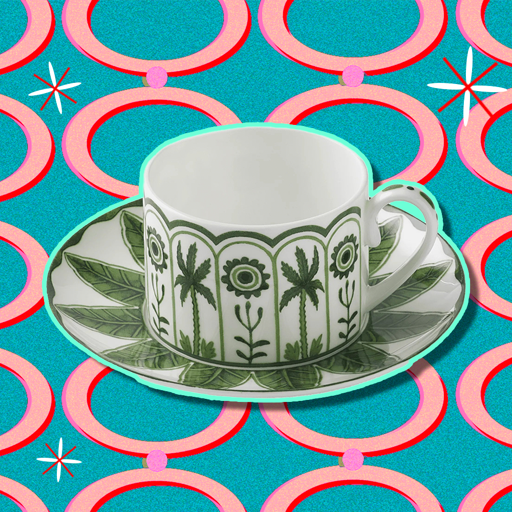 A porcelain cup and saucer with a green design