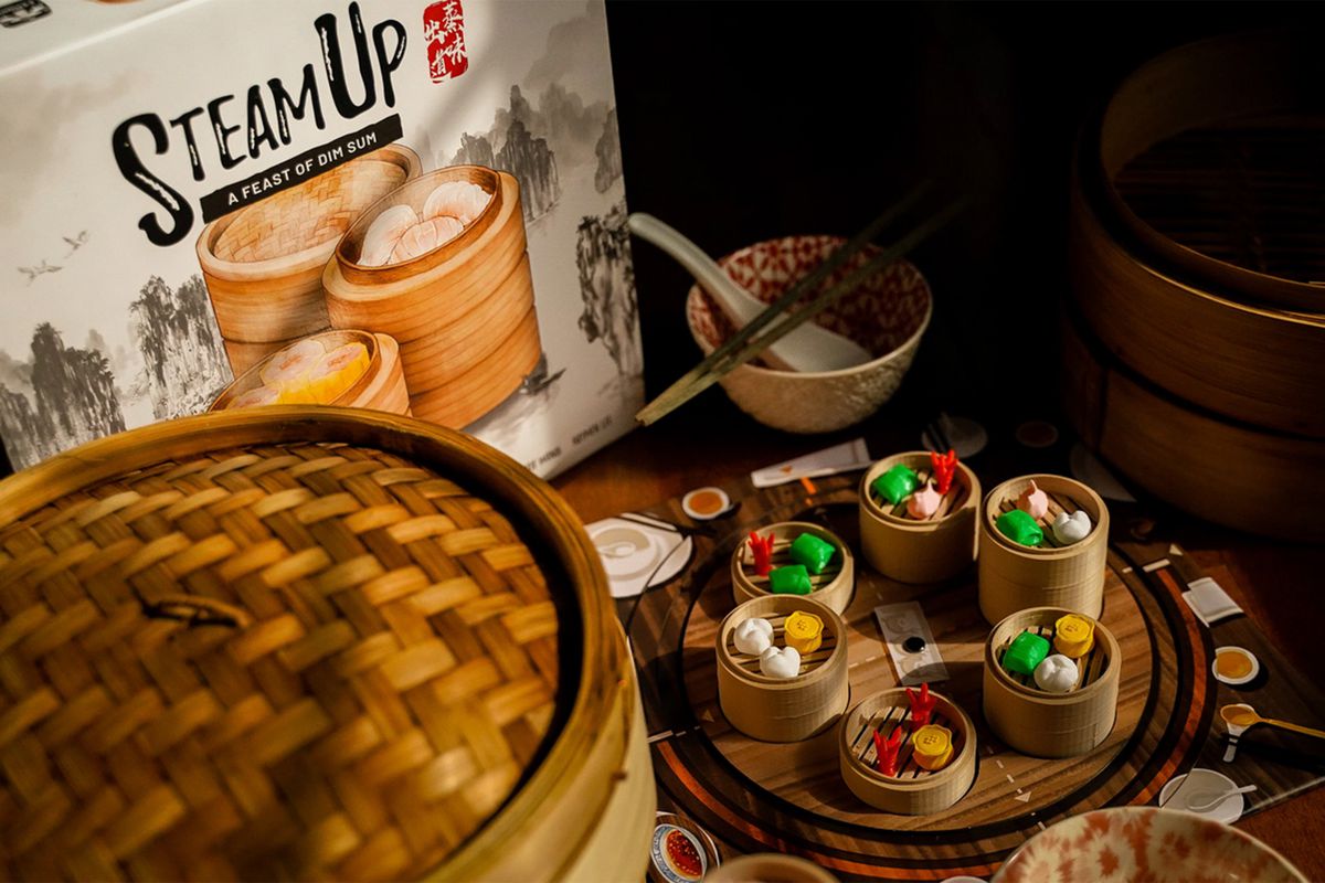 Real bamboo steamers sit next to tiny, plastic ones filled with squishy food — the core components of the deluxe edition of Steam Up.