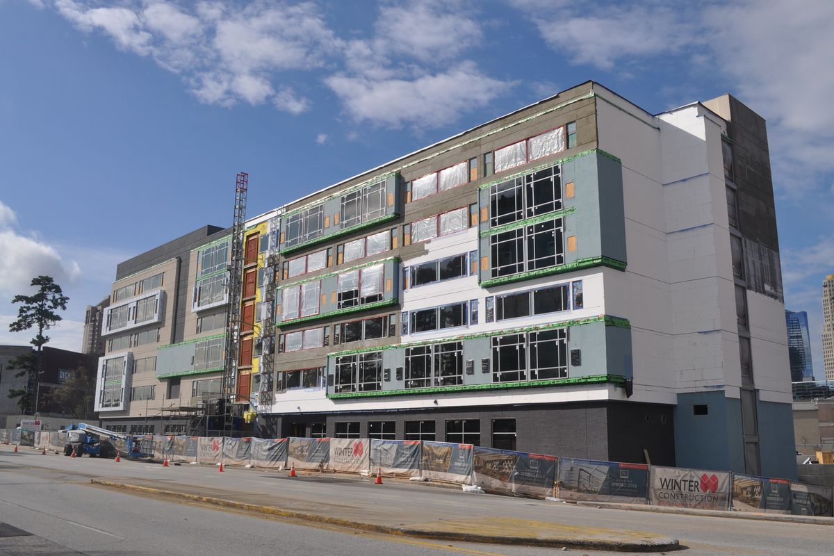 Windows are installed and paint is going up at the boxy seven-story modern hotel.