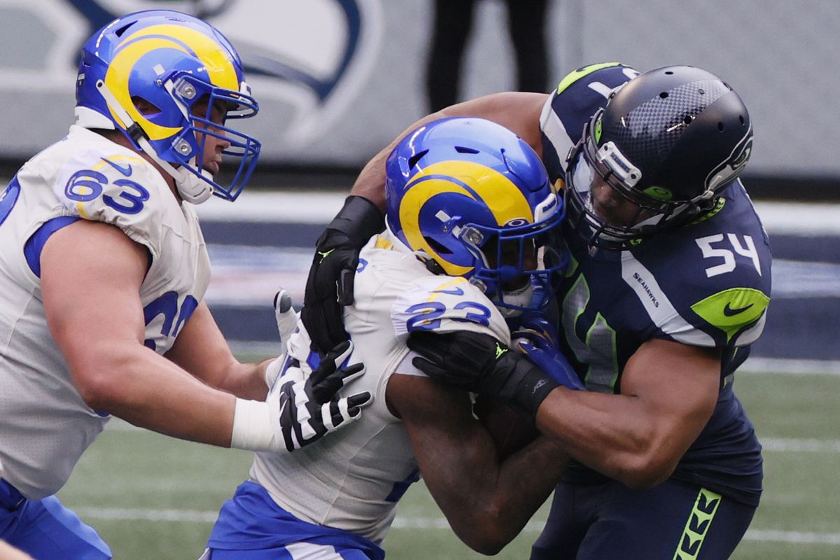 Middle linebacker Bobby Wagner #54 of the Seattle Seahawks tackles running back Cam Akers #23 of the Los Angeles Rams during the first quarter of the NFC Wild Card Playoff game at Lumen Field on January 09, 2021 in Seattle, Washington.