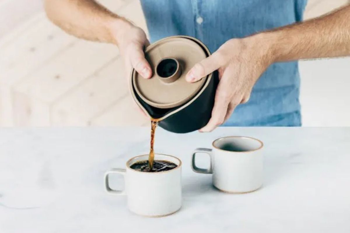 Man pouring coffee into cup