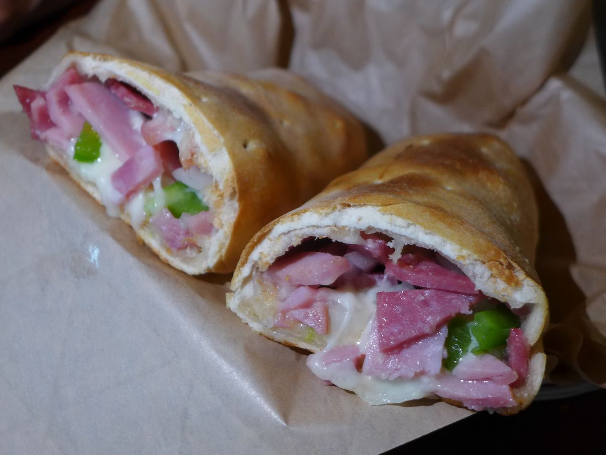 Two pastry tubes filled with cheese and meat.