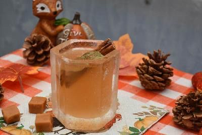 A holiday cocktail with a cinnamon stick.