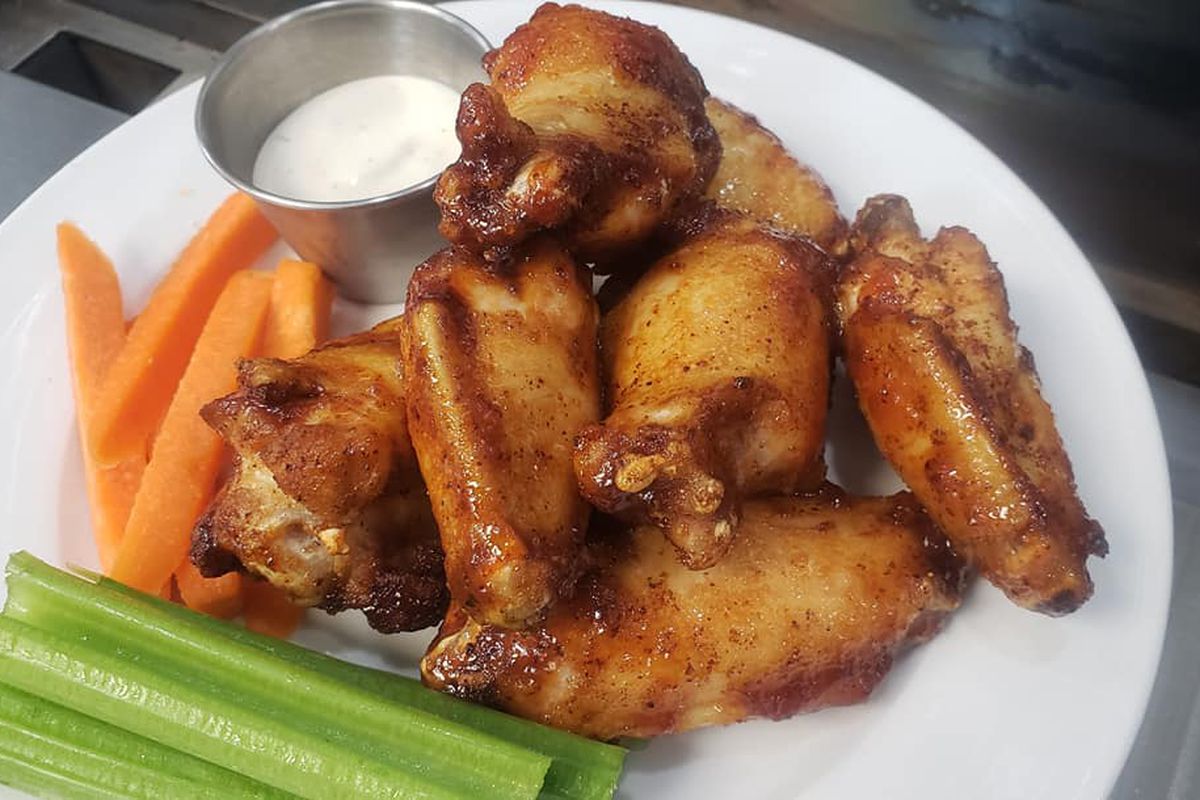 A plate of chicken wings, ranch dip, carrot sticks, and celery sticks at the Harp in Grant Park