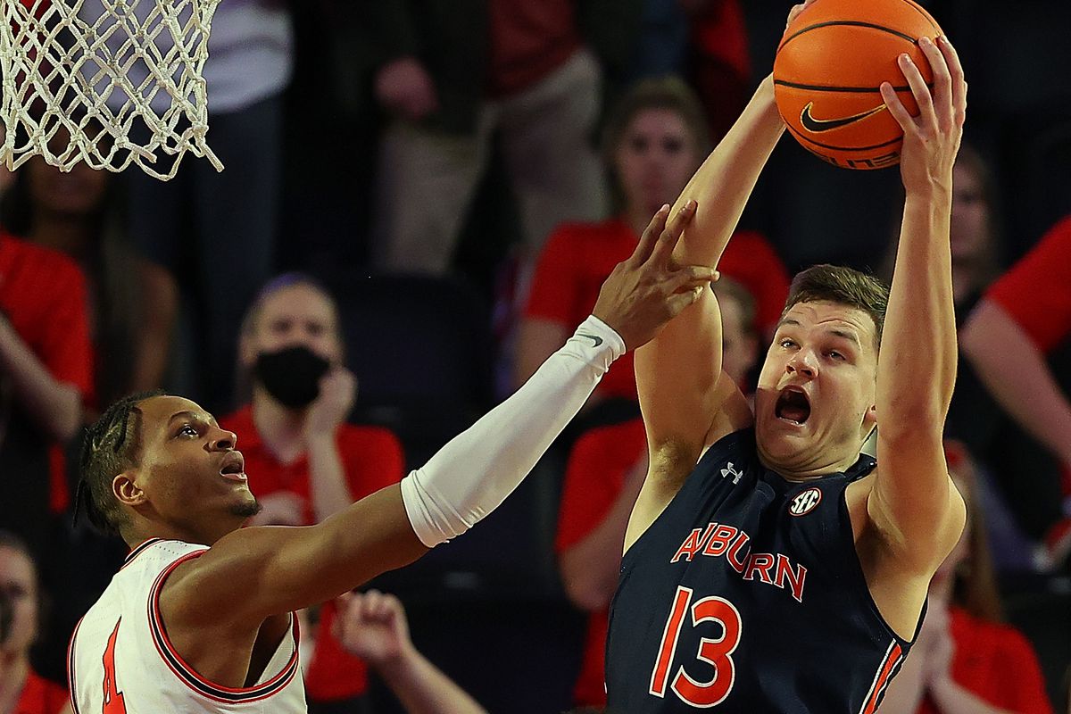 Walker Kessler of the Auburn Tigers grabs a rebound against Tyron McMillan of the Georgia Bulldogs during the second half at Stegeman Coliseum on February 05, 2022 in Athens, Georgia.