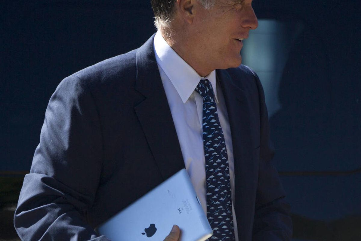 Republican presidential candidate, former Massachusetts Gov. Mitt Romney, carries an iPad as he walks into the Church of Jesus Christ of Latter-day Saints on Sunday, Aug. 19, 2012, in Wolfeboro, N.H. 