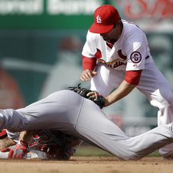 Cincinnati Reds' Chris Heisey, bottom, is safe at second for a double ahead of the tag from St. Louis Cardinals shortstop Pete Kozma during the fourth inning of a baseball game, Monday, April 8, 2013, in St. Louis. (AP Photo/Jeff Roberson)