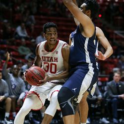 Utah Utes guard Gabe Bealer (30) drives against Concordia’s Tre' Vance during a game at the Hunstman Center in Salt Lake City on Tuesday, Nov. 15, 2016.