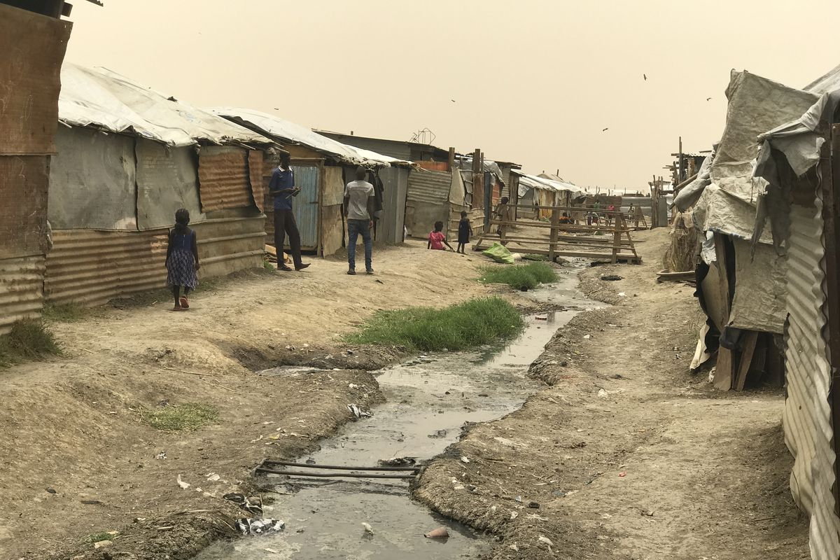 Sewage runs between shacks in Malakal 'Protection of Civilians' site. POCs are what the UN calls these fortified, guarded camps where people fleeing tribal violence live.