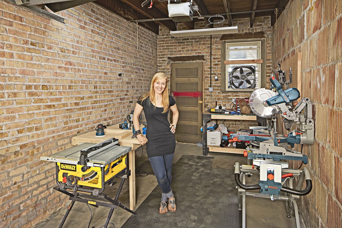 A homeowner standing in her newly updated garage workshop.