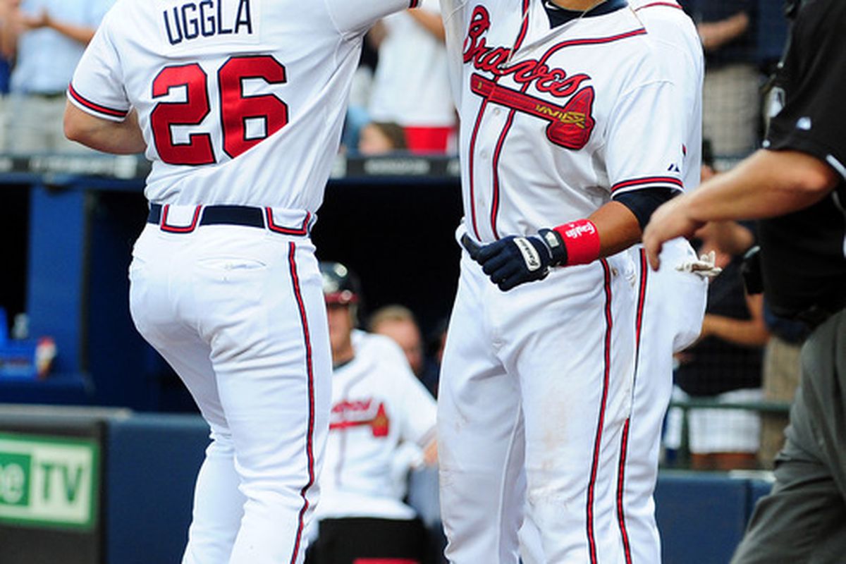 ATLANTA - JULY 30: Dan Uggla #26 of the Atlanta Braves is congratulated by Martin Prado #14 after hitting a home run against the Florida Marlins at Turner Field on July 30, 2011 in Atlanta, Georgia. (Photo by Scott Cunningham/Getty Images)