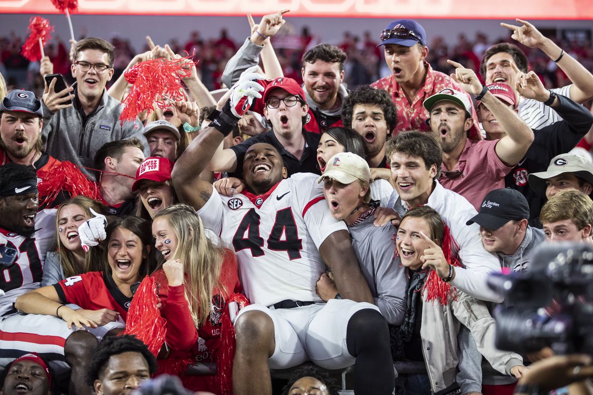 Travon Walker of the Georgia Bulldogs celebrates with fans after defeating the Florida Gators 34-7 in a game at TIAA Bank Field on October 30, 2021 in Jacksonville, Florida.