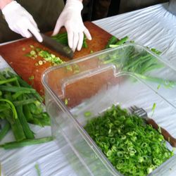 Servers prepare and chop ingredients for the summer rolls served at Toki Underground and Woodberry Kitchen.